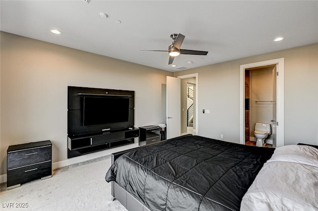 carpeted bedroom featuring baseboards, ensuite bath, a ceiling fan, and recessed lighting