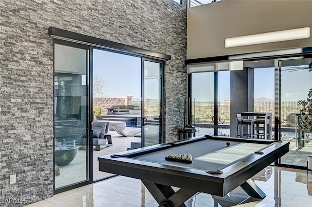 recreation room featuring a ceiling fan, tile patterned flooring, pool table, and a high ceiling