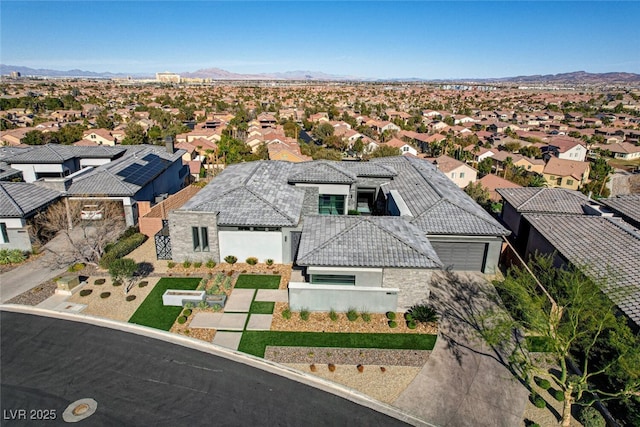 drone / aerial view featuring a residential view and a mountain view