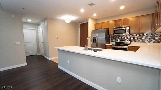 8255 Las Vegas Blvd Unit 415, Las Vegas, NV 89123 - kitchen featuring stainless steel appliances, a peninsula, dark wood-style floors, tasteful backsplash, and recessed lighting