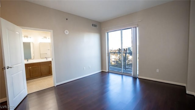 8255 Las Vegas Blvd Unit 415, Las Vegas, NV 89123 - unfurnished bedroom with access to outside, dark wood-type flooring, and connected bathroom