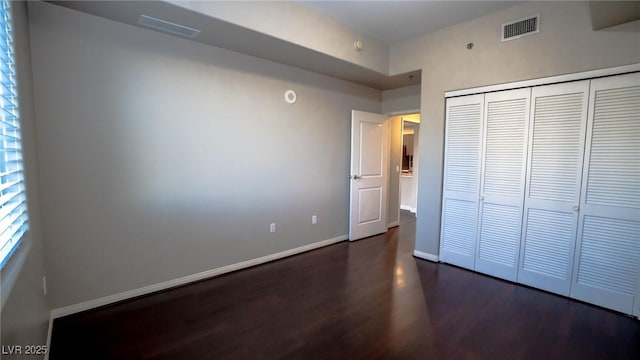 8255 Las Vegas Blvd Unit 415, Las Vegas, NV 89123 - unfurnished bedroom featuring dark wood-type flooring and a closet