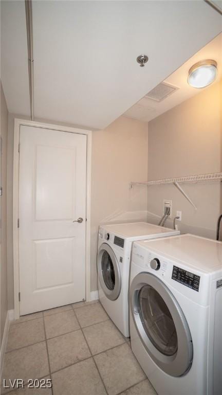 8255 Las Vegas Blvd Unit 415, Las Vegas, NV 89123 - laundry room with washer and clothes dryer and light tile patterned flooring