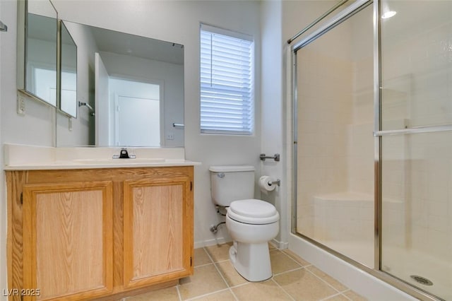 full bathroom featuring toilet, a stall shower, tile patterned floors, and vanity