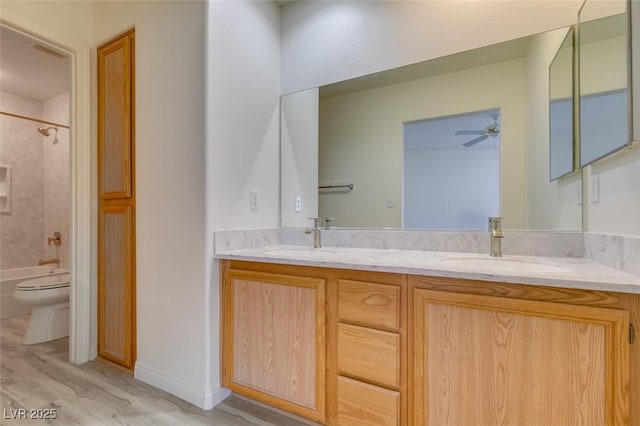 full bathroom with bathtub / shower combination, a sink, toilet, and double vanity