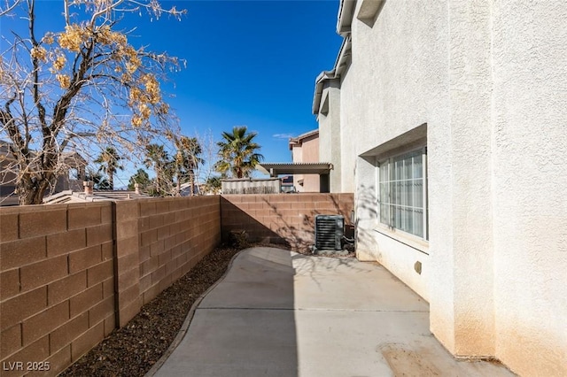 exterior space with central air condition unit and a fenced backyard