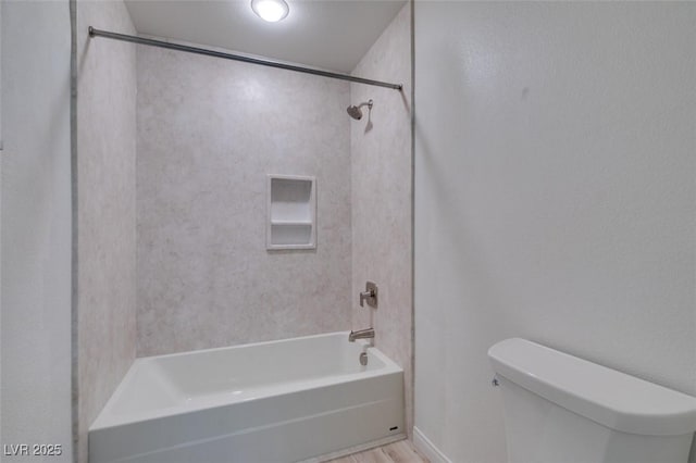 bathroom with toilet, bathtub / shower combination, and wood finished floors