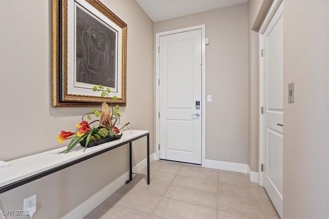 interior space with light tile patterned floors and baseboards