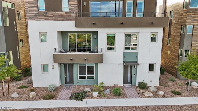 exterior space featuring a balcony and stucco siding