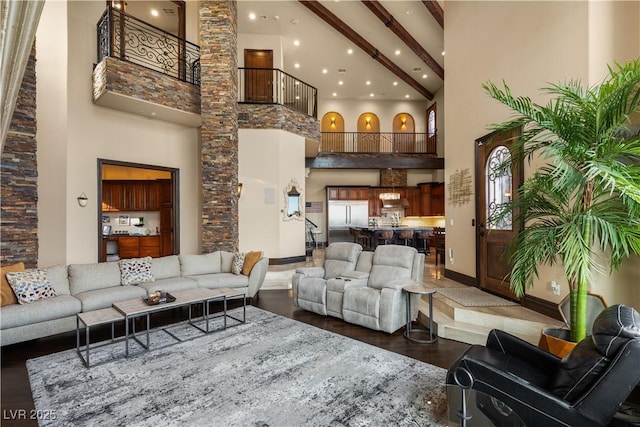 living area featuring baseboards, a towering ceiling, dark wood-style floors, beamed ceiling, and recessed lighting