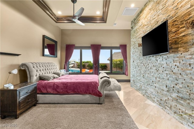 bedroom featuring ornamental molding, a raised ceiling, visible vents, and ceiling fan