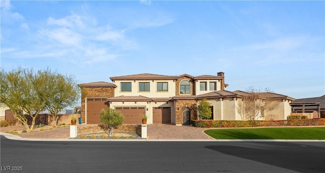 view of front of home with driveway, a garage, and fence