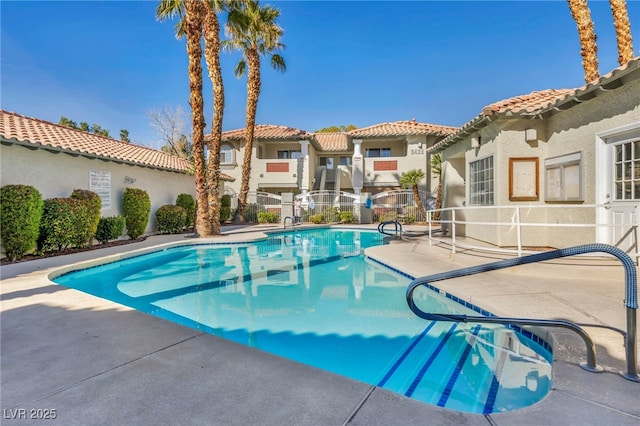 community pool featuring a patio area and a residential view