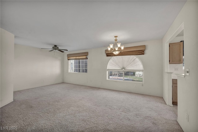 unfurnished room with light carpet and ceiling fan with notable chandelier