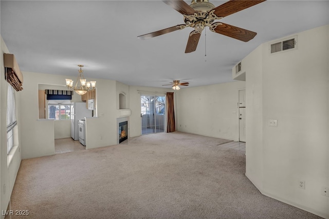 unfurnished living room with light carpet, visible vents, and a tile fireplace