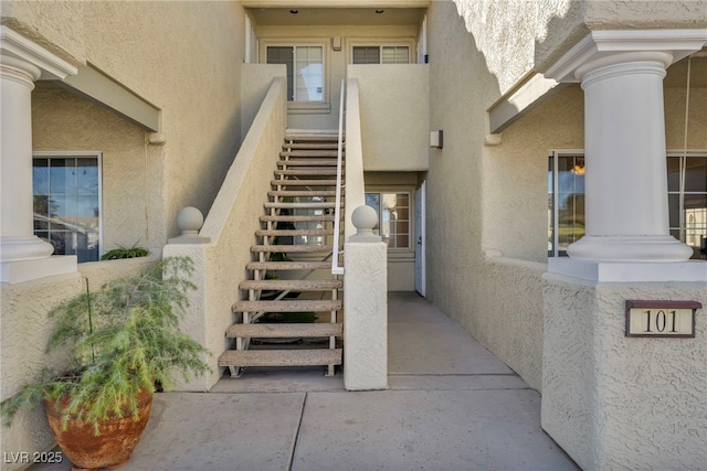 doorway to property featuring stucco siding