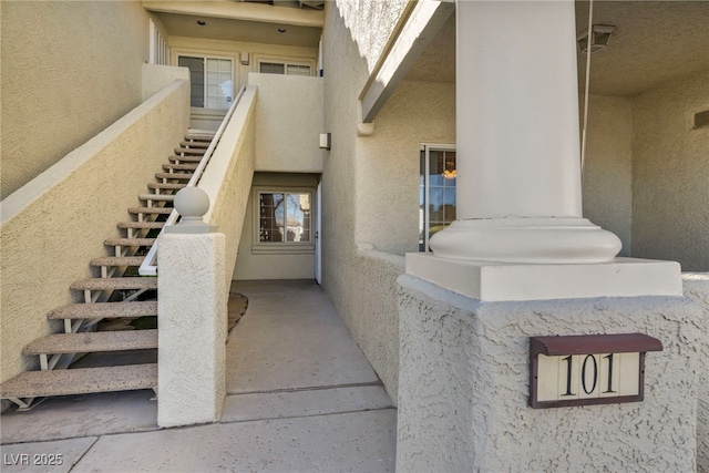 doorway to property with stucco siding