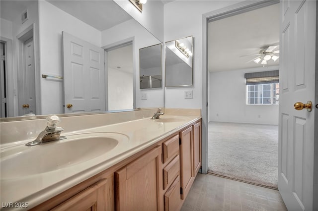 bathroom with a ceiling fan, visible vents, a sink, and double vanity