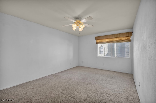 unfurnished room featuring a ceiling fan and light colored carpet