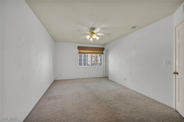 spare room with light carpet and a ceiling fan