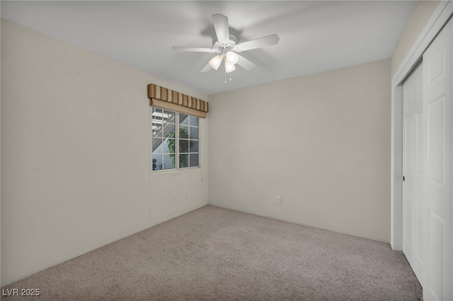 unfurnished bedroom featuring ceiling fan, a closet, and carpet flooring