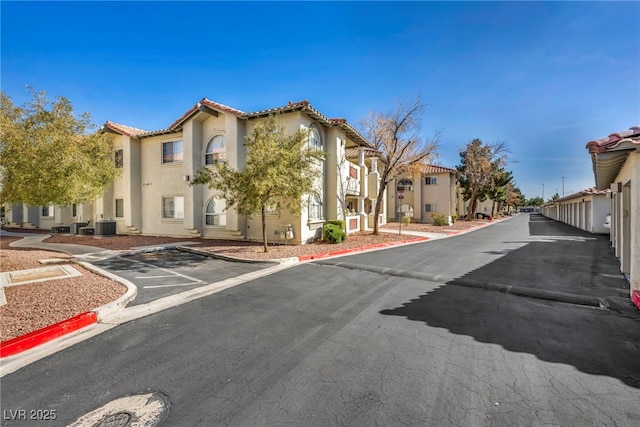 view of road featuring a residential view and curbs