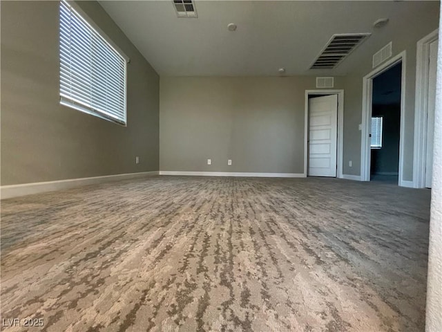 spare room with baseboards and visible vents