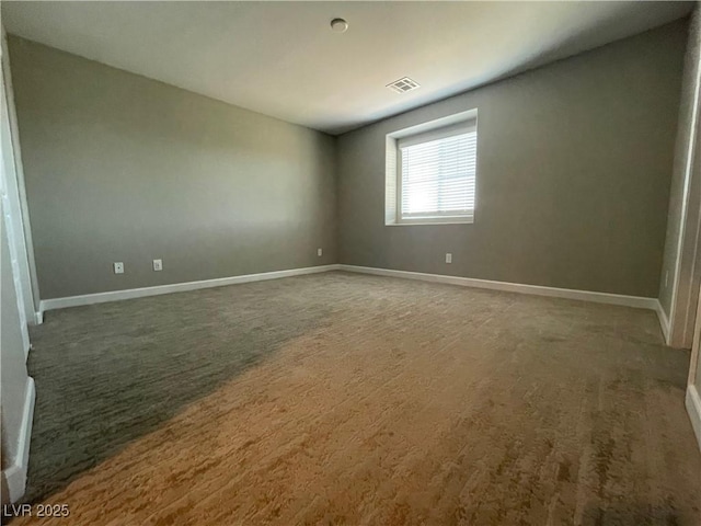 carpeted empty room with baseboards and visible vents