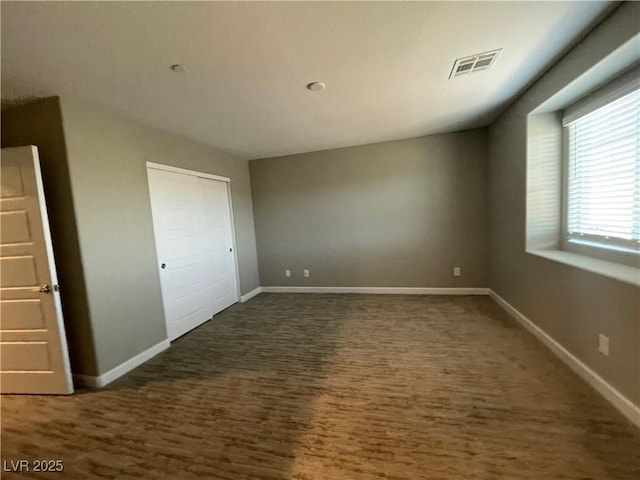 unfurnished bedroom featuring baseboards and visible vents