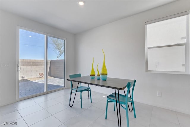 dining space featuring light tile patterned flooring