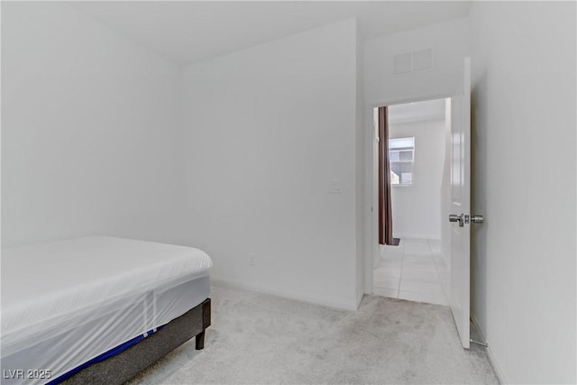 bedroom with light carpet, visible vents, and baseboards