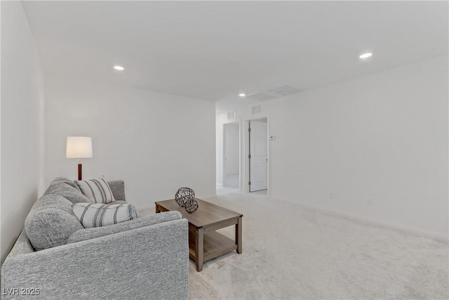 living area featuring recessed lighting, visible vents, and light colored carpet