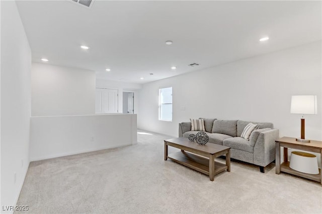 living area with recessed lighting, visible vents, and light colored carpet