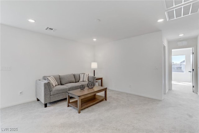 living room with recessed lighting, visible vents, and light colored carpet