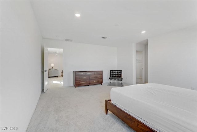 bedroom with recessed lighting, light carpet, and visible vents