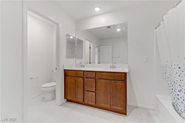 full bath with visible vents, double vanity, a sink, and toilet