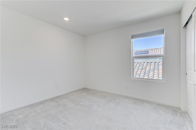 unfurnished room featuring recessed lighting and carpet flooring