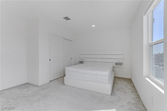 unfurnished bedroom featuring carpet floors and visible vents