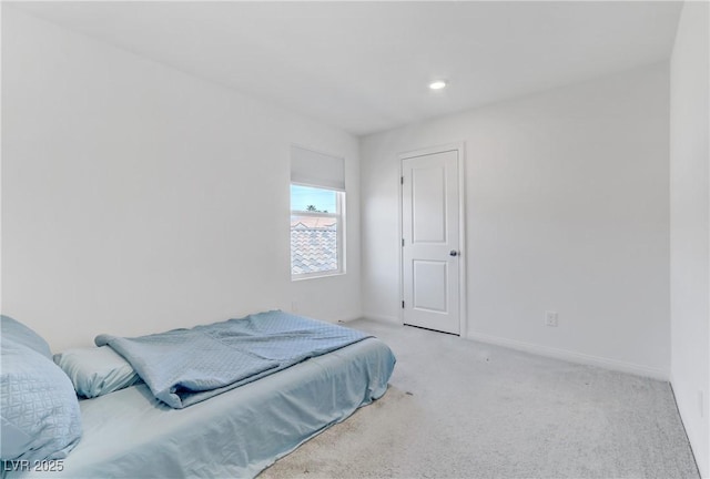 bedroom with carpet floors and baseboards