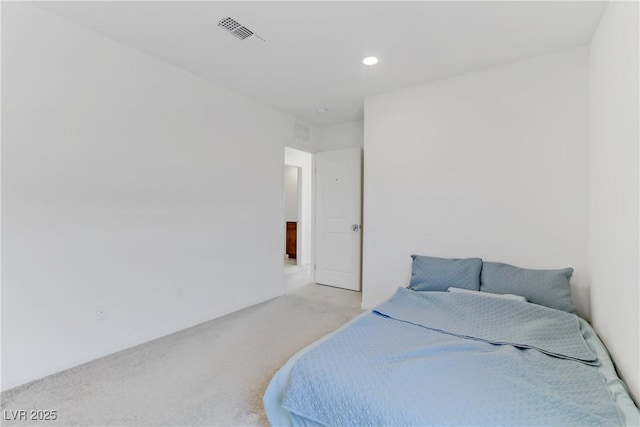 bedroom featuring recessed lighting, visible vents, and light carpet