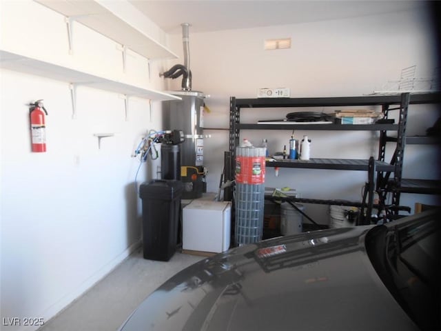 garage with secured water heater and baseboards