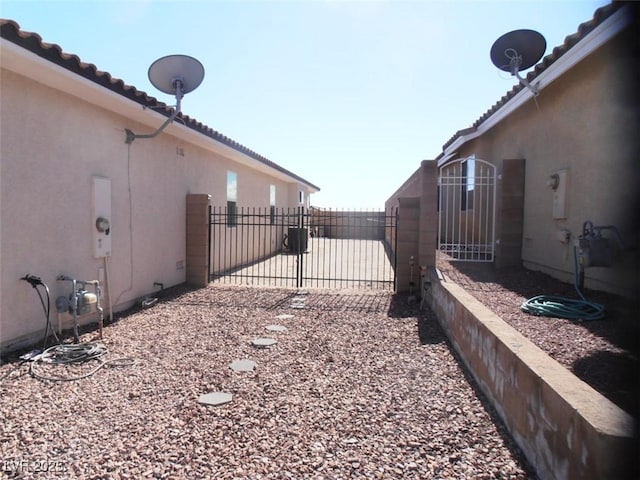 view of home's exterior featuring a gate, fence, and stucco siding