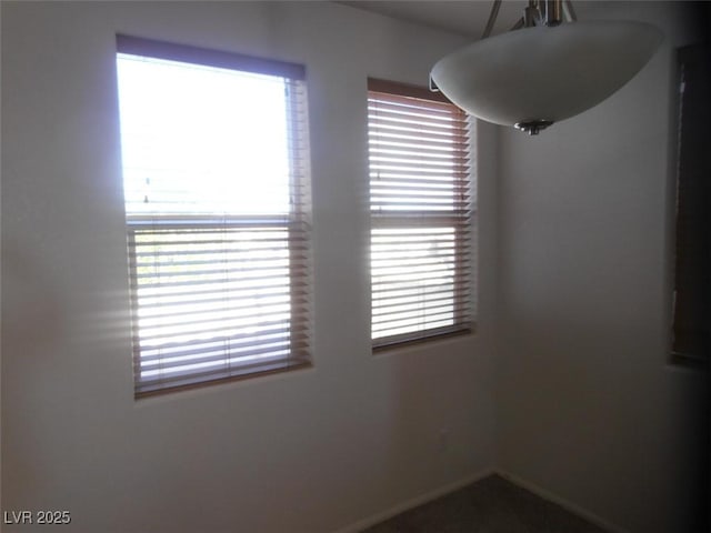 unfurnished room featuring baseboards