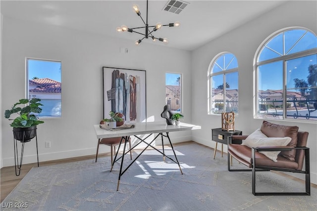 office with baseboards, light wood-style flooring, visible vents, and a notable chandelier