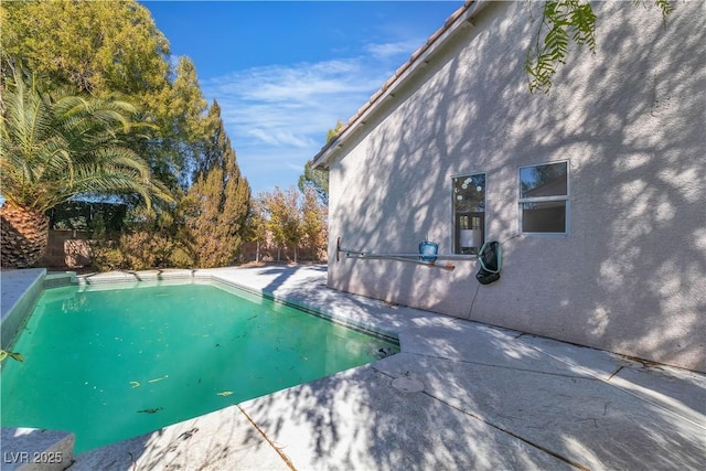 outdoor pool with a patio area