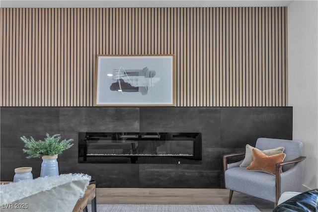 interior space featuring a glass covered fireplace and wood finished floors