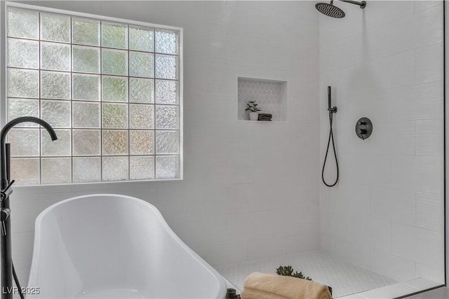 full bath with a freestanding bath and tiled shower