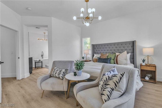 bedroom featuring light wood-type flooring, an inviting chandelier, and baseboards