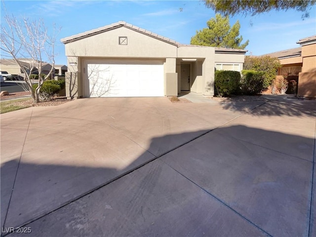 view of front of property featuring driveway, a garage, and stucco siding