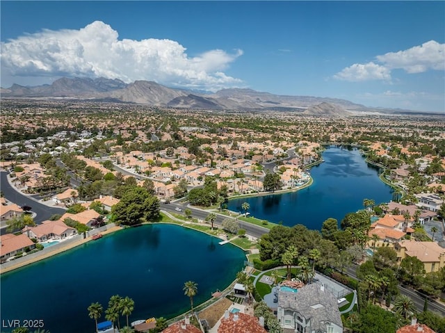 drone / aerial view featuring a residential view and a water and mountain view